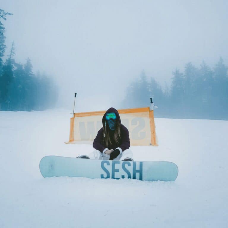sesh woman on snowboard in the snow