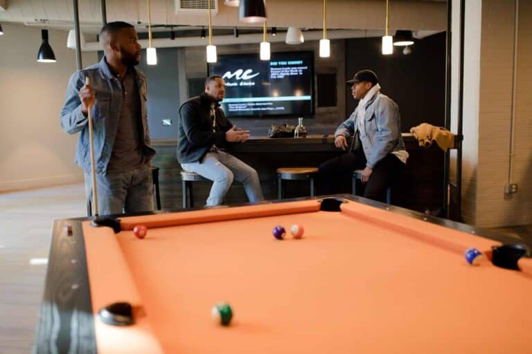 3 men hanging out in man cave