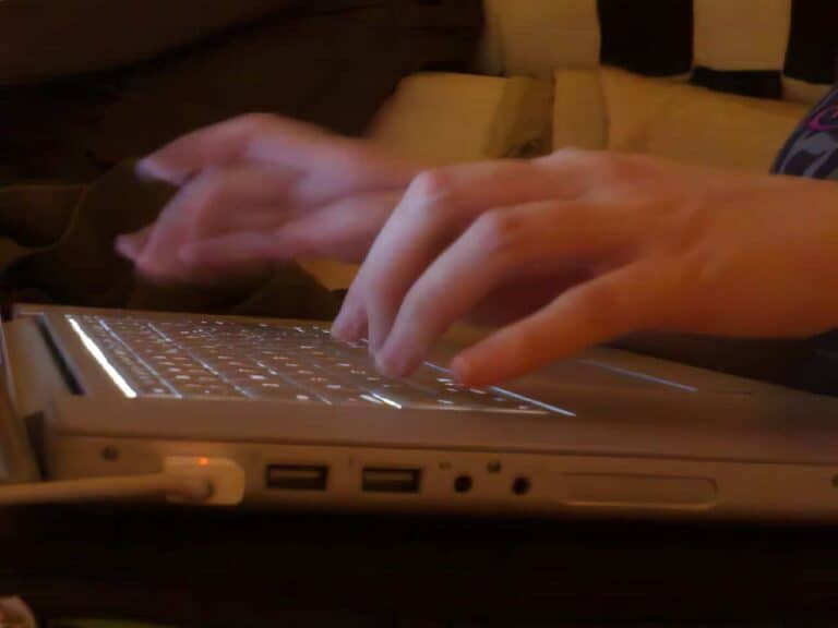 person typing very old computer