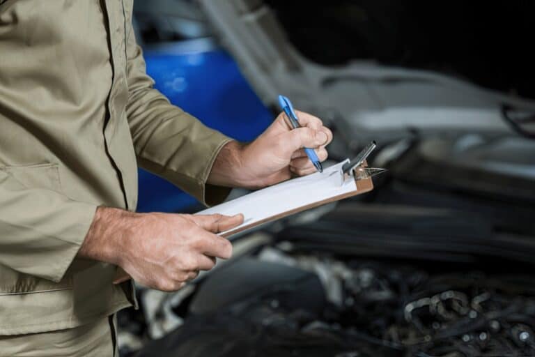 person writing on clipboard