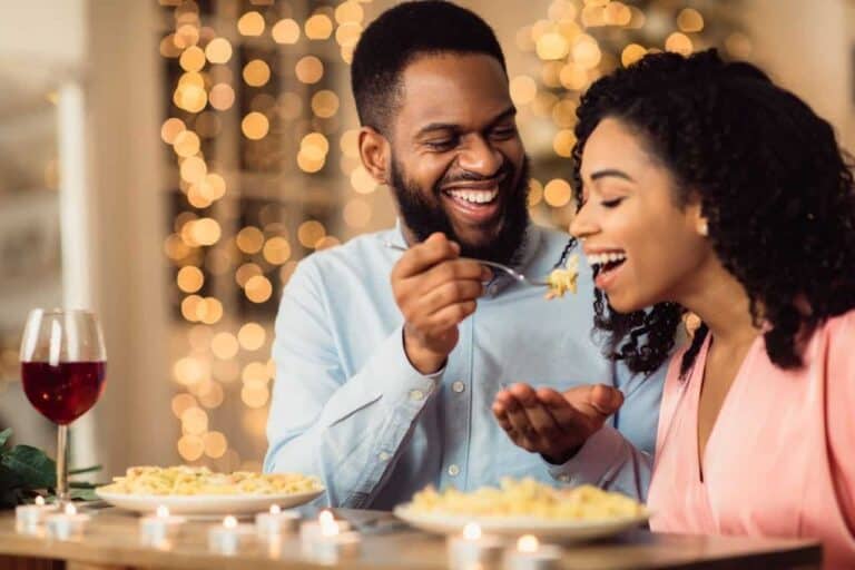 man feeding woman food