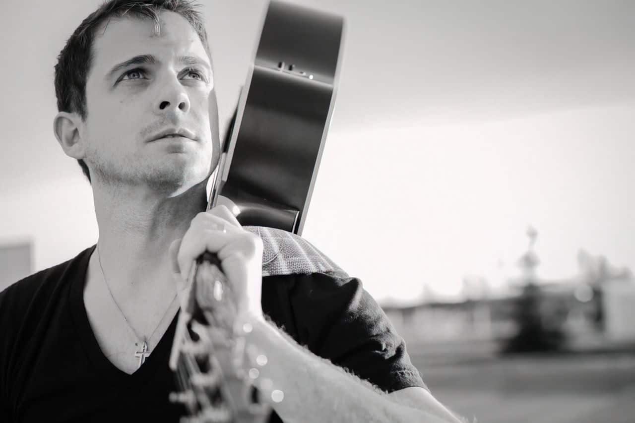 Things That Influence Men's Style That Isn't Clothes 3 man holding guitar upscaled
