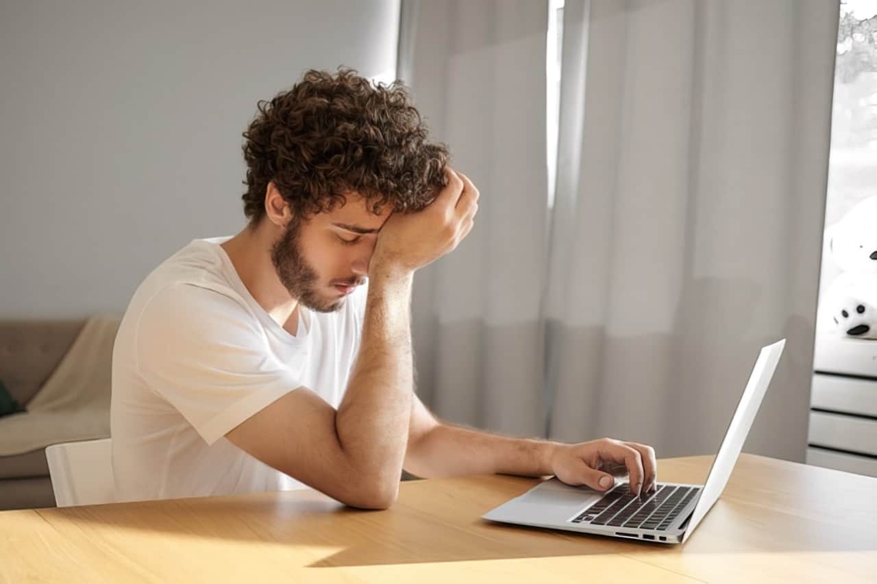 stressed person looking at computer upscaled
