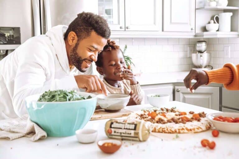father making pizza with daughter
