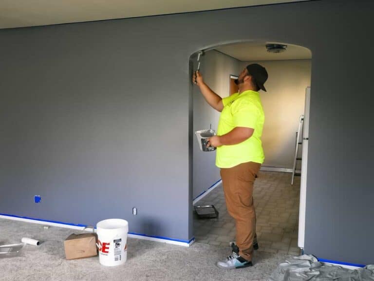 man painting his walls