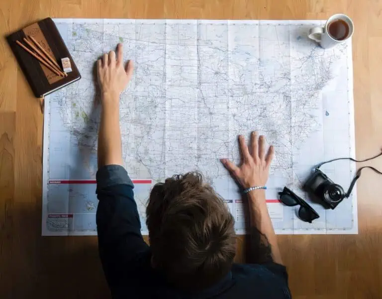 person pointing at paper map