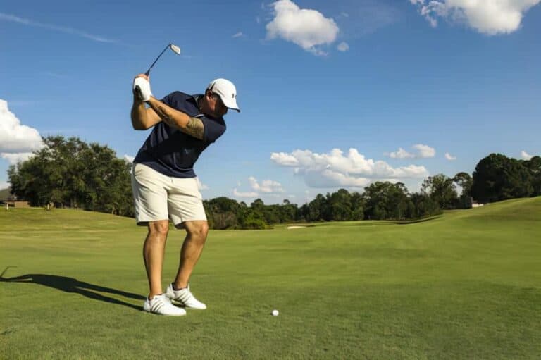 swinging golf club