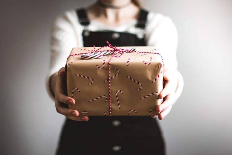 woman handing man a gift