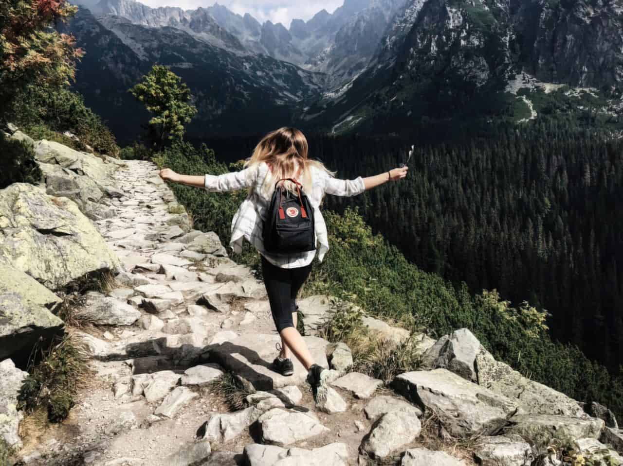 woman skipping down the mountain