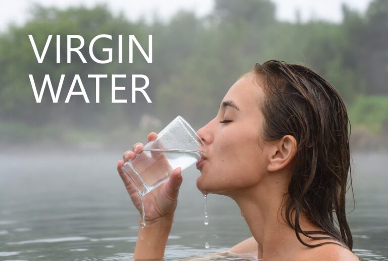 Refreshing woman drinking water in natural outdoor setting for health and wellness.