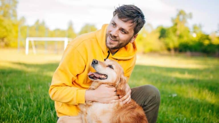 man cuddling dog 1 1