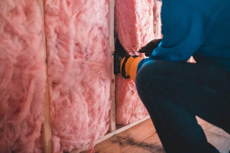 person installing insulation