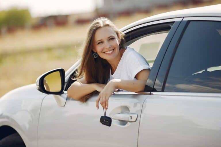 woman leaning out car window