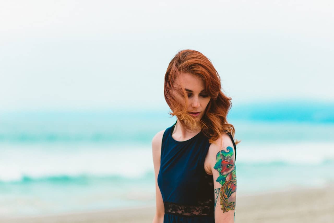 woman with tattoo on the beach