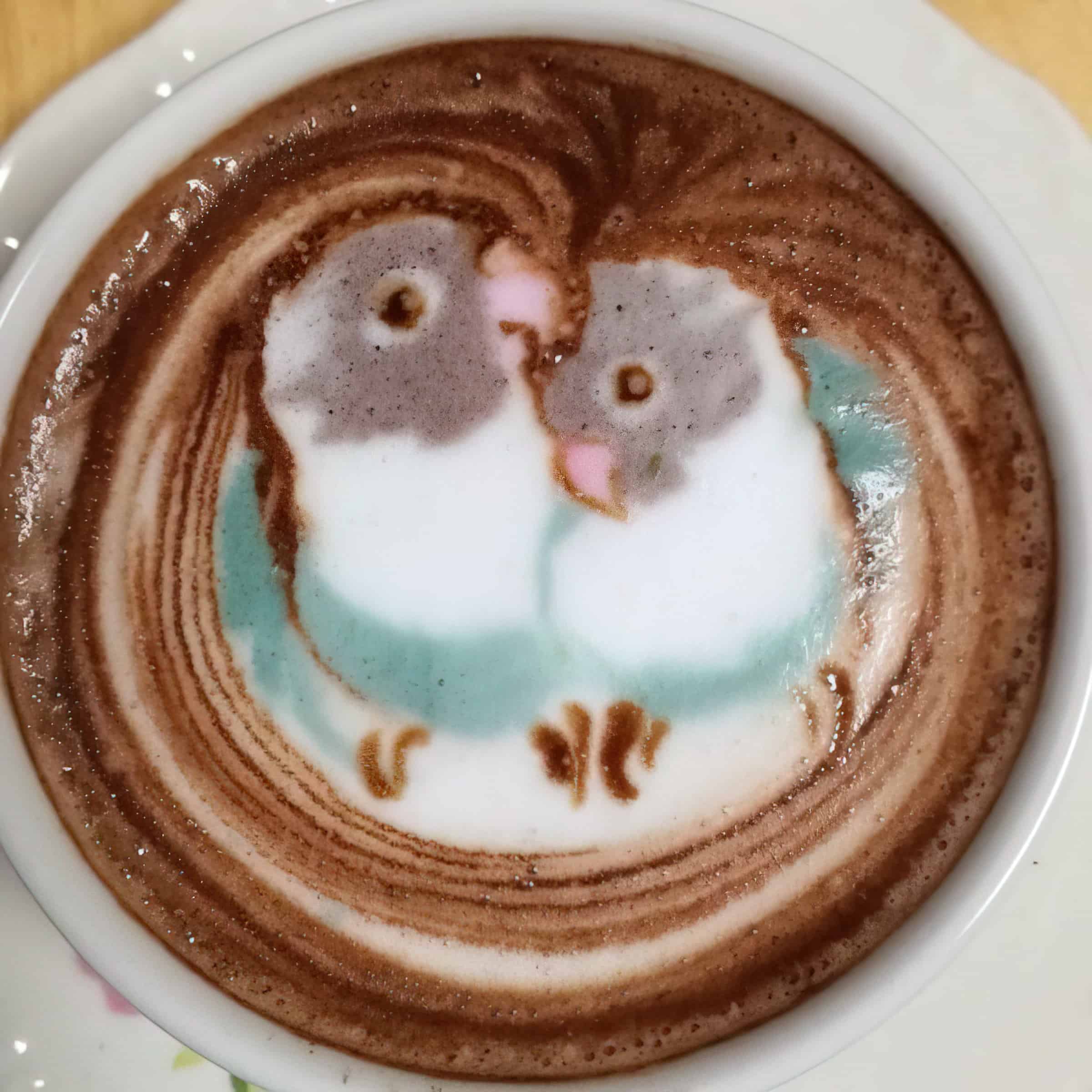 latte art of two birds