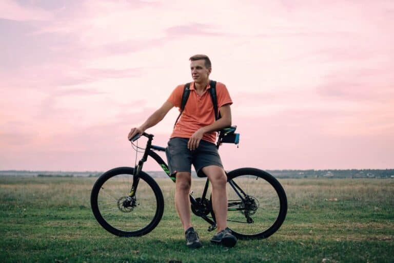 man sitting on his bike resting
