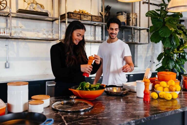 man and woman cooking in kitchen