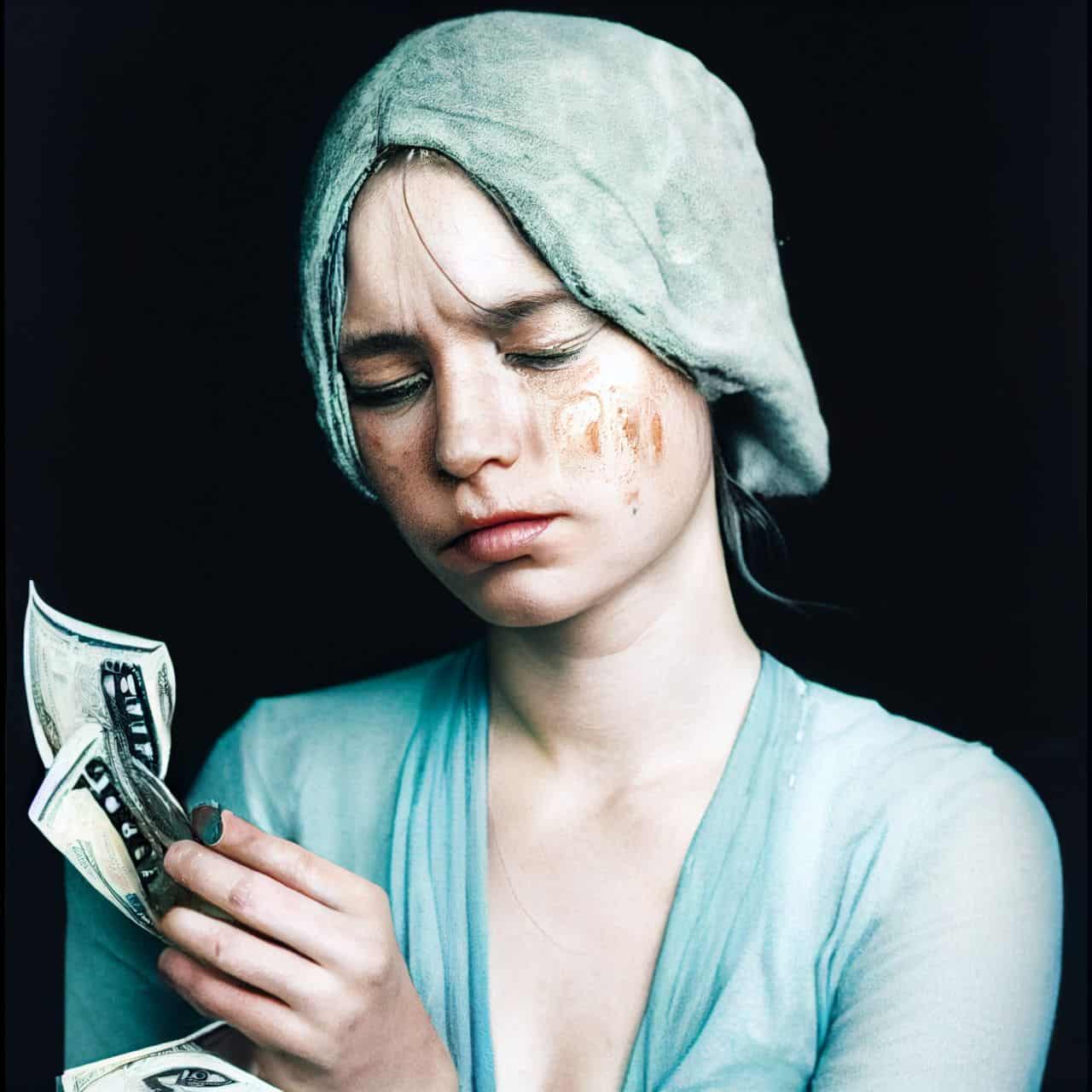 crying woman holding money