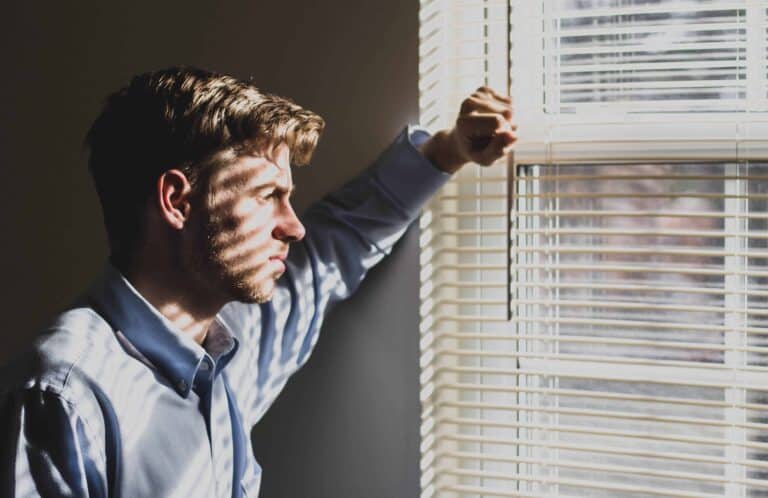 Man looking outside window