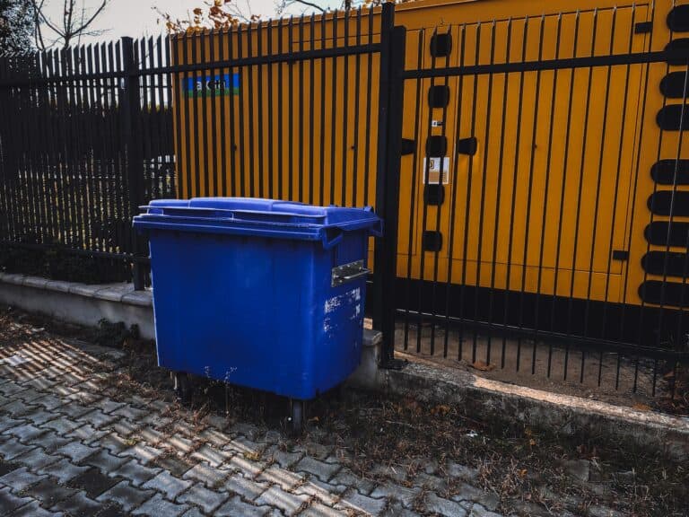 dumpster by fence
