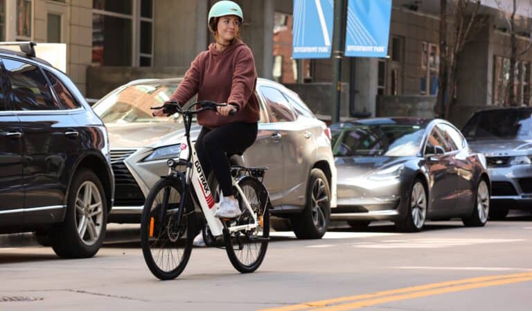 A pretty girl riding an electric bike in the city