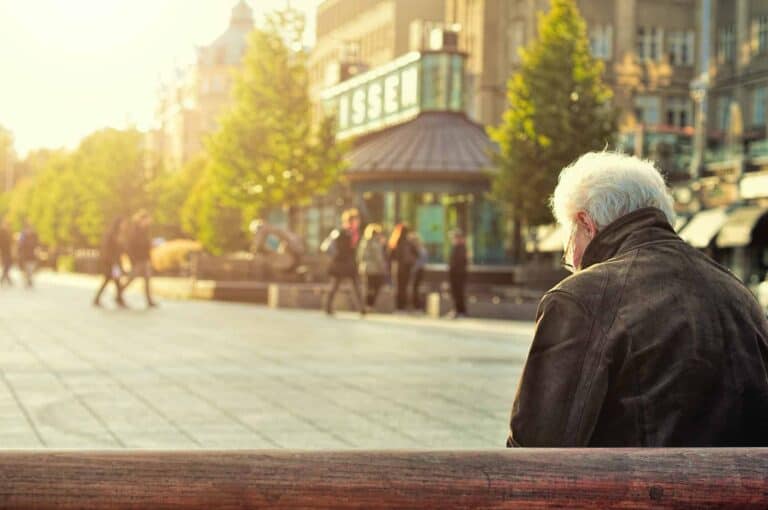 retired man sitting on bench