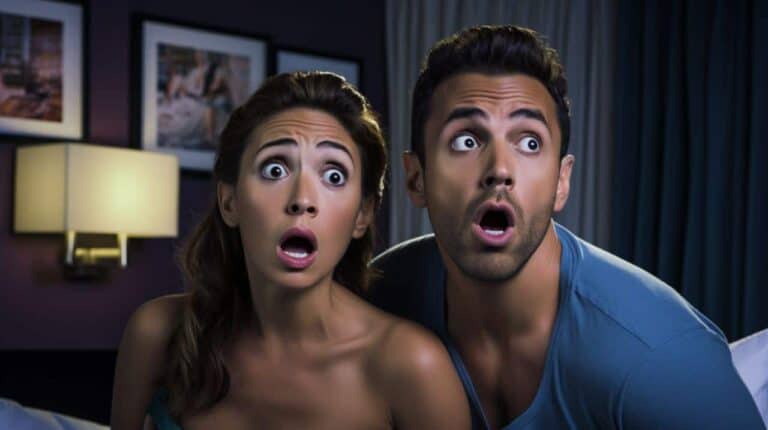 couple watching hotel room tv shocked faces