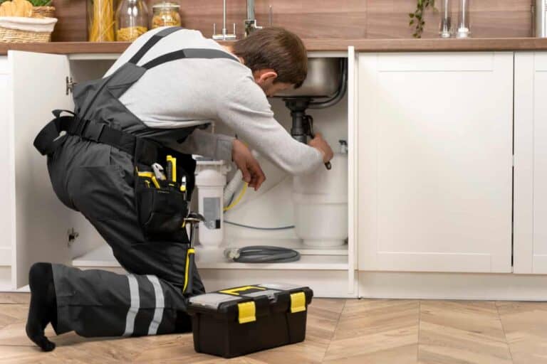 plumber fixing sink