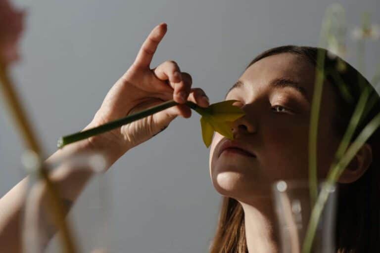 woman smelling flower