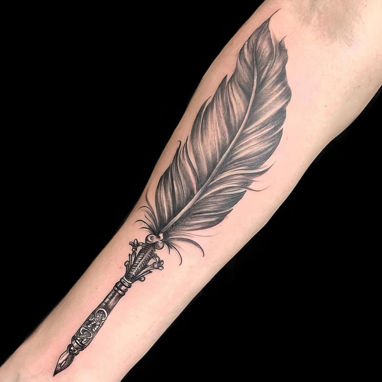 Cute feather tattoo on the forearm Inked by Black Poison Tattoos