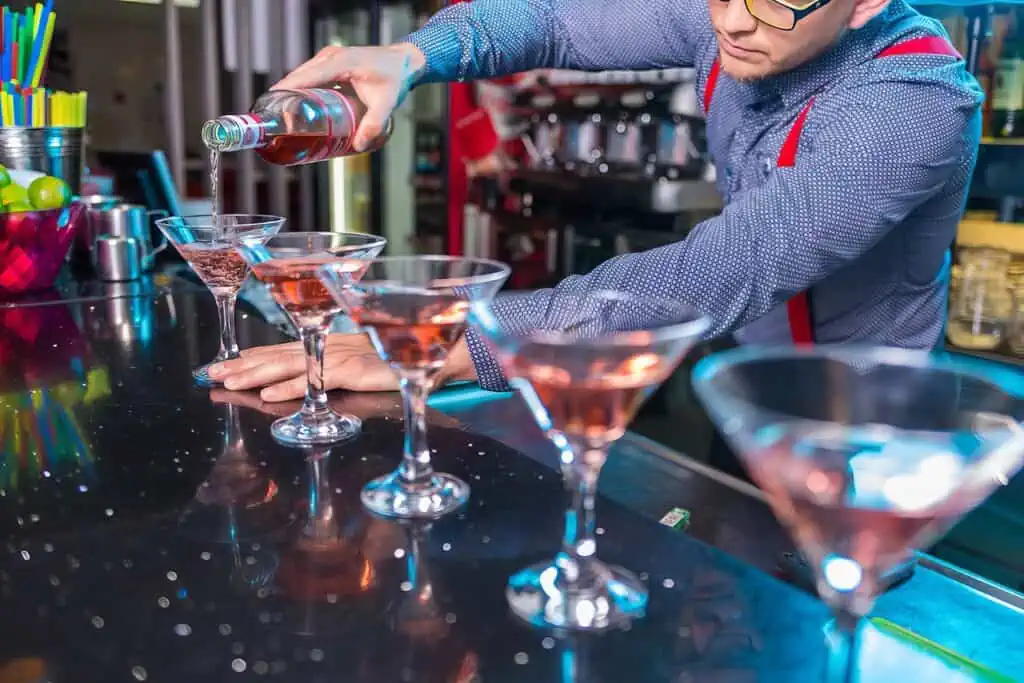 Can Bartenders Drink on the Job? Navigating Murky Laws and Regulations 3 bartender pouring a drink