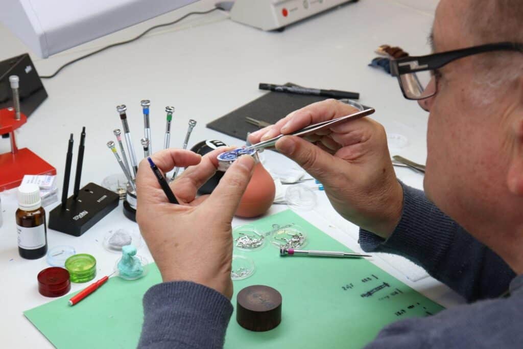 What Makes Tufina Watches So Desirable? 2 Watchmaker working on Tufina Watch