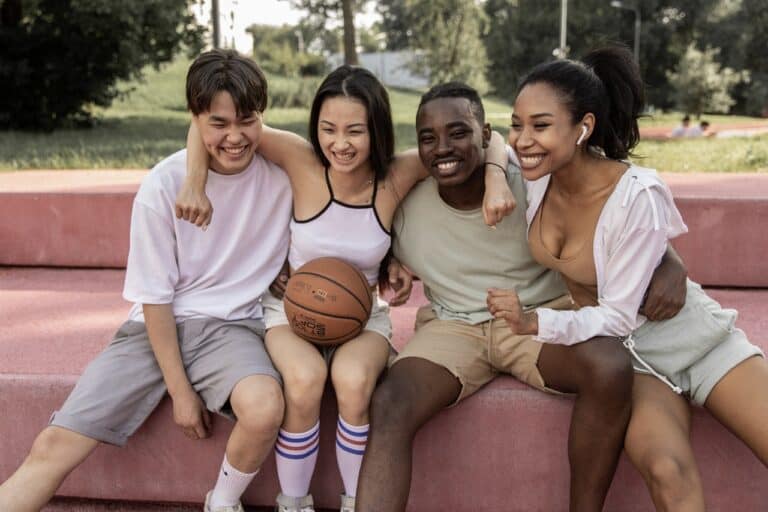 people hugging playing sports