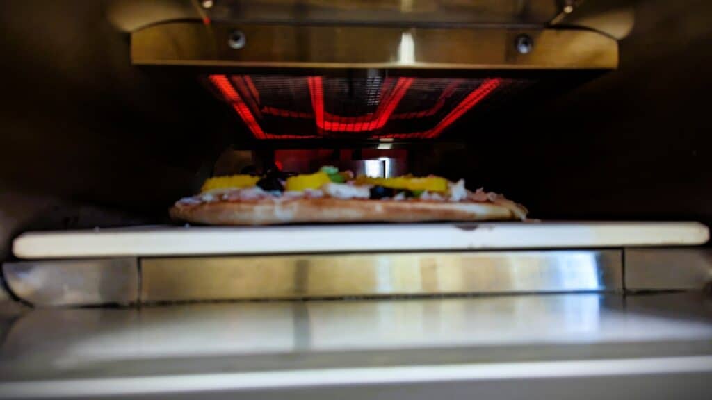 Newair 12" Portable Electric Pizza Oven Review: Your Perfect Slice Awaits 2 Newair 12 inch Portable Electric Pizza Oven Cooking pizza