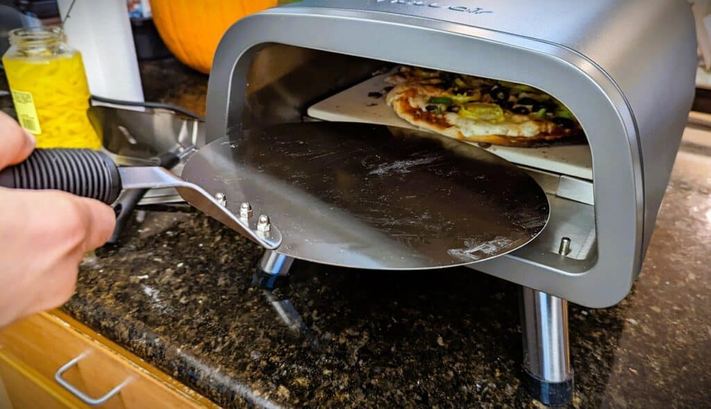 Newair 12" Portable Electric Pizza Oven Review: Your Perfect Slice Awaits 3 Newair 12 inch Portable Electric Pizza Oven sliding in pizza