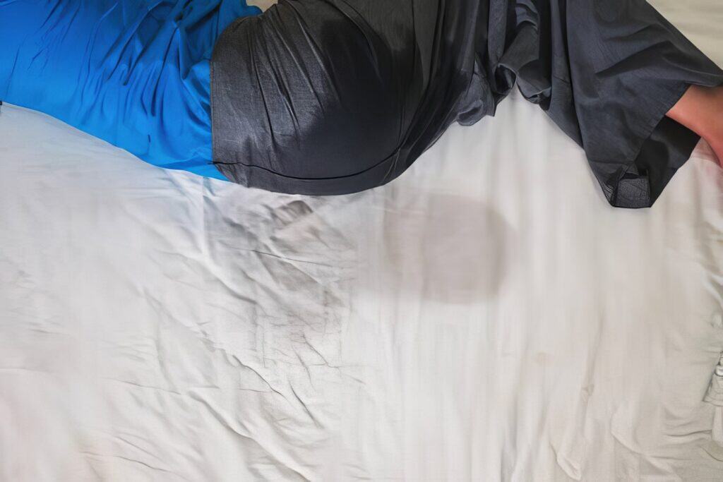 A couple in casual clothing carefully make the bed in a softly lit bedroom. Girlfriend Wets the Bed 1