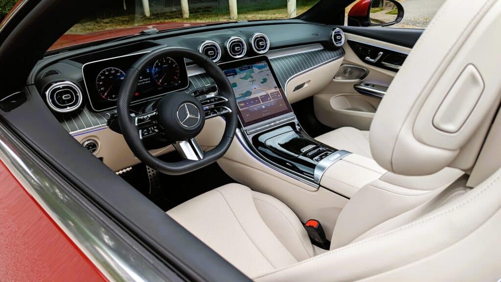 2025 Mercedes-Benz CLE 300 4MATIC Cabriolet Review 10 Luxury car interior featuring a Mercedes-Benz dashboard, advanced touchscreen navigation, and beige leather seats for a premium driving experience.