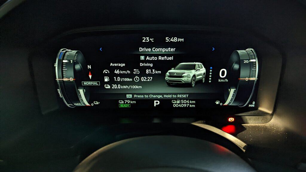 2025 Mitsubishi Outlander PHEV Noir Review 3 Beautiful vehicle dashboard display showing fuel efficiency, vehicle status, and driving stats on a modern car digital instrument cluster.