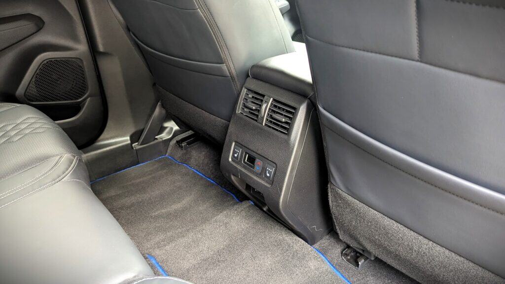 2025 Mitsubishi Outlander PHEV Noir Review 11 Comfortable car interior with rear air vents and climate controls, showcasing a modern and sleek design ideal for a smooth driving experience.