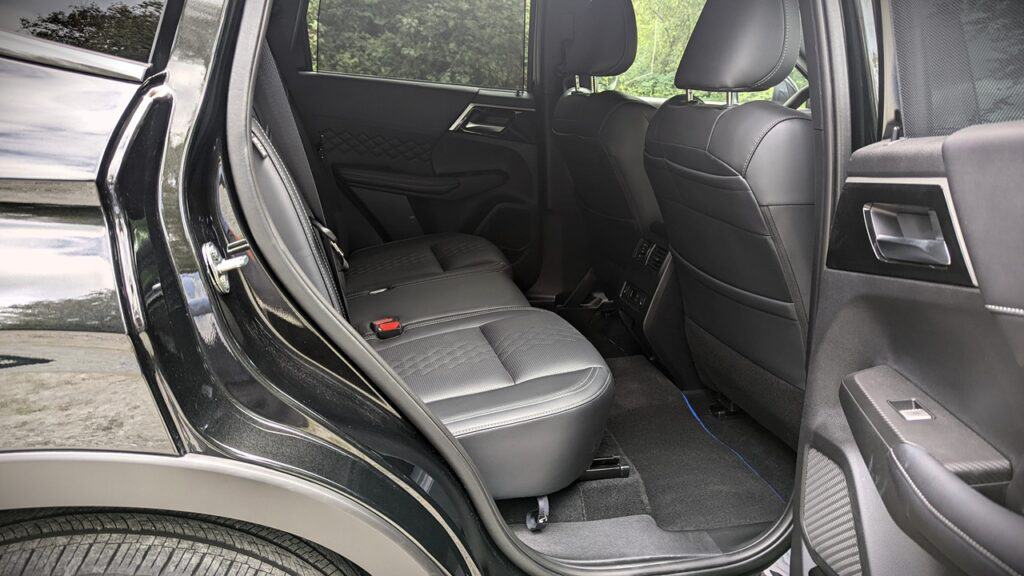 2025 Mitsubishi Outlander PHEV Noir Review 12 Spacious black leather rear car seats with headrests, modern interior design, and ample legroom, ideal for comfortable backseat travel and premium vehicle comfort.