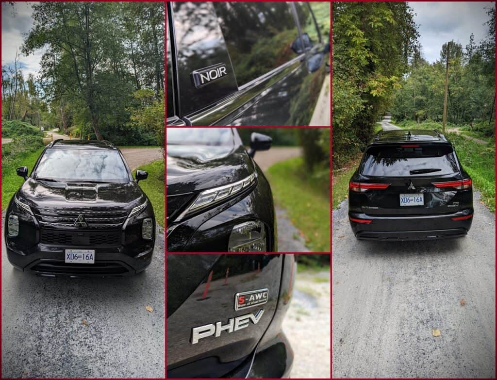 2025 Mitsubishi Outlander PHEV Noir Review 4 Black Mitsubishi Outlander SUV parked on a rural road surrounded by green trees and foliage.