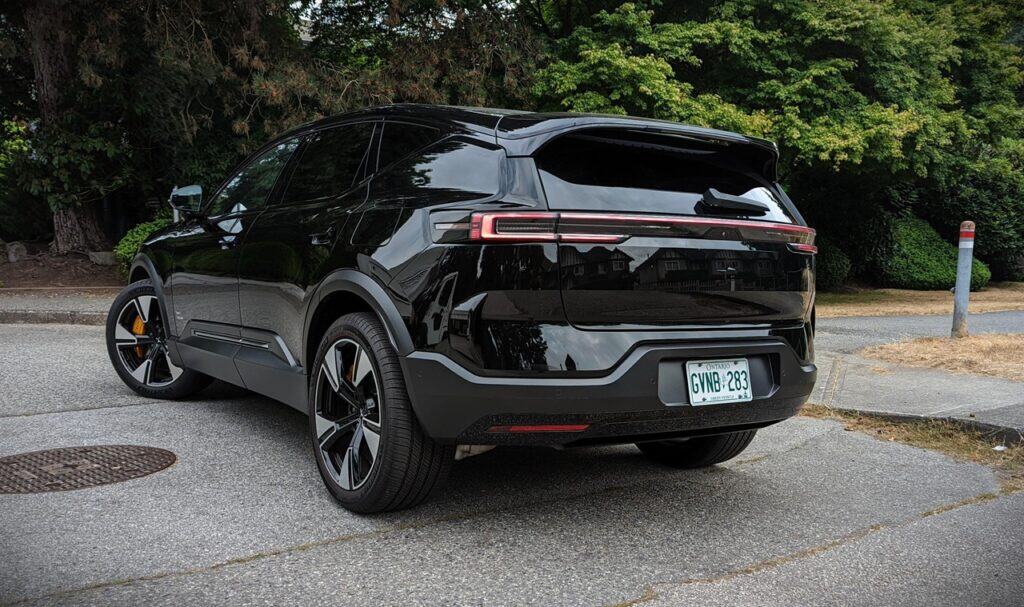 2025 Polestar 3 Long Range Dual Motor Review 8 Genuine black electric SUV parked on the street with lush greenery in the background, showcasing modern car design and eco-friendly vehicle technology.