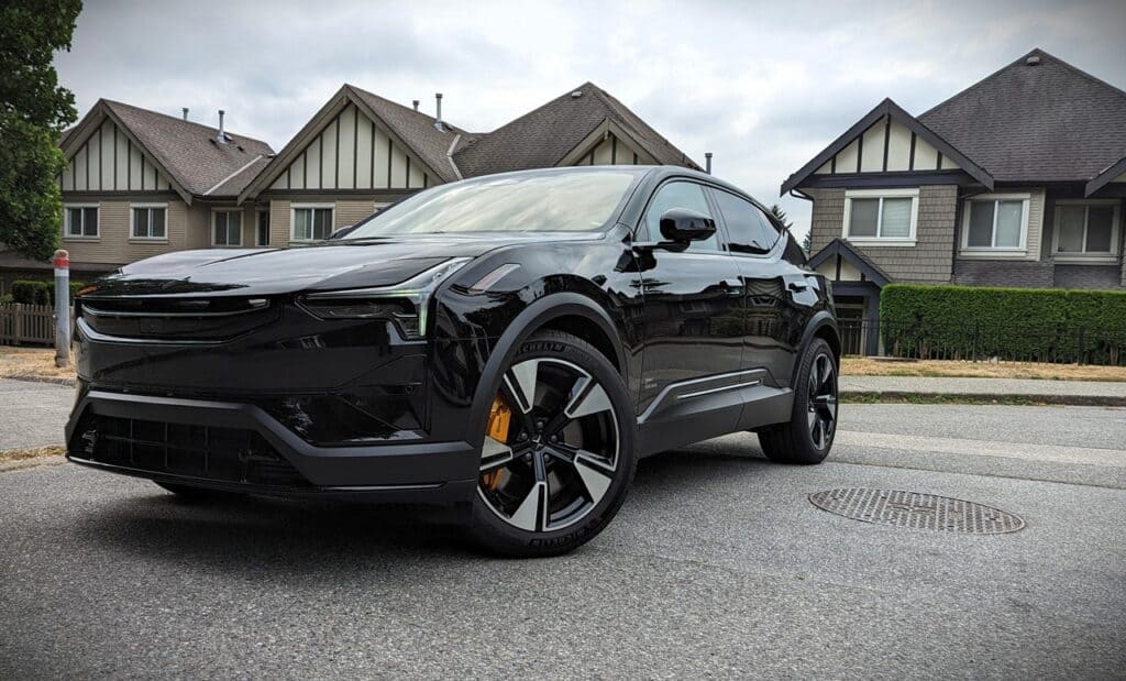 2025 Polestar 3 Long Range Dual Motor Review 6 Black SUV parked in residential neighborhood under cloudy sky.