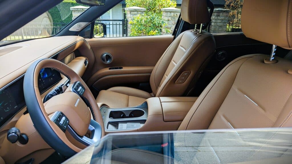 2026 Hyundai Pallisade Ultimate Calligraphy Review 13 Luxurious tan leather interior inside a modern vehicle showing the front seats, dashboard, and steering wheel. Perfect for automotive enthusiasts interested in premium car features and interior design.