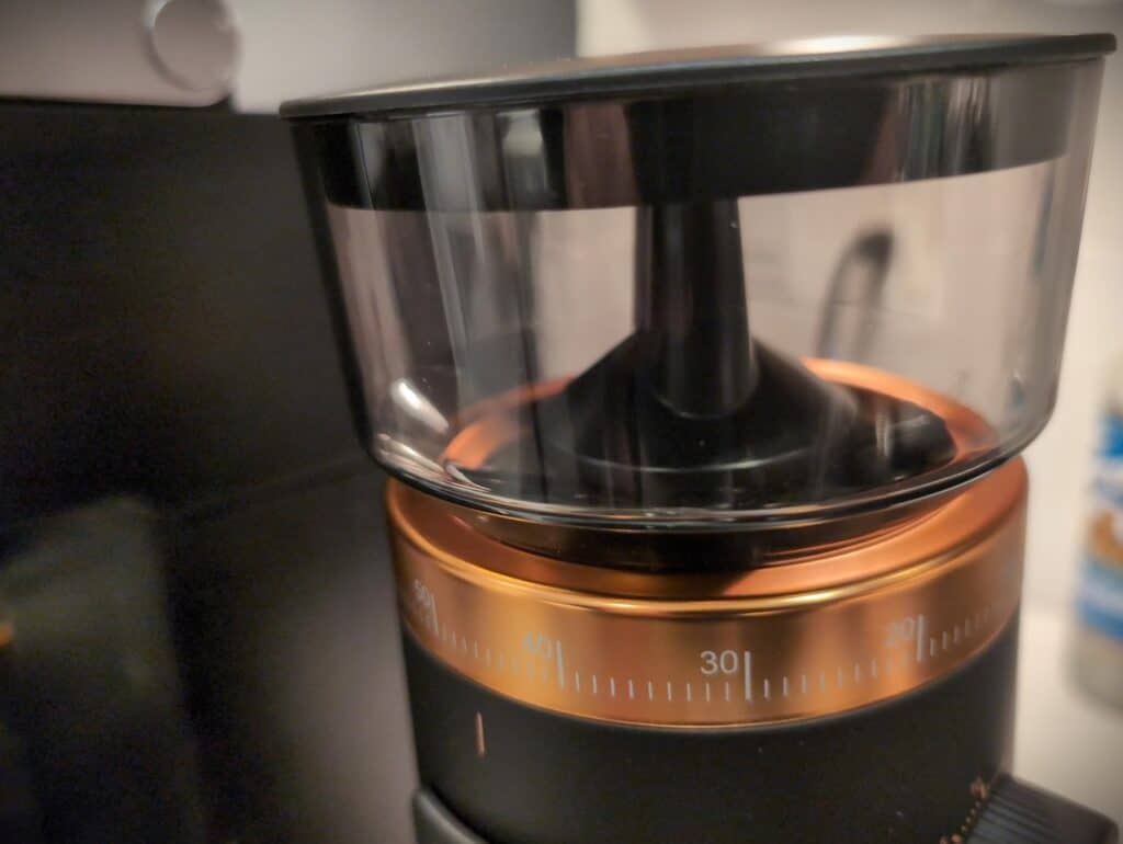 Shredding machine for food processing with black and copper design, showing a clear plastic lid and timer dial. Ideal for kitchen enthusiasts who enjoy preparing meals efficiently and stylishly.