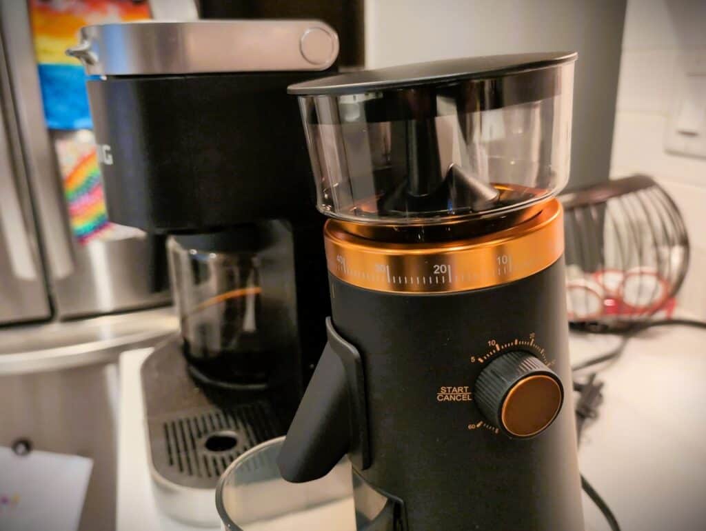 Blender and coffee machine on a kitchen countertop, modern appliances for preparing drinks.