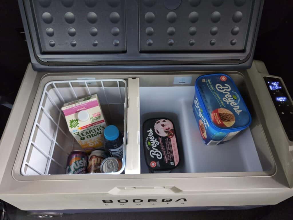BODEGAcooler 36L Dual Zone 12V Portable Car Fridge Review 5 Cold storage freezer with ice cream, frozen drinks, and beverages inside, ideal for keeping food fresh and chilled.