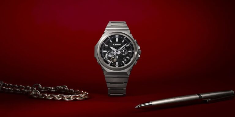 Luxury men's watch from G-Shock collection displayed on a deep red background.