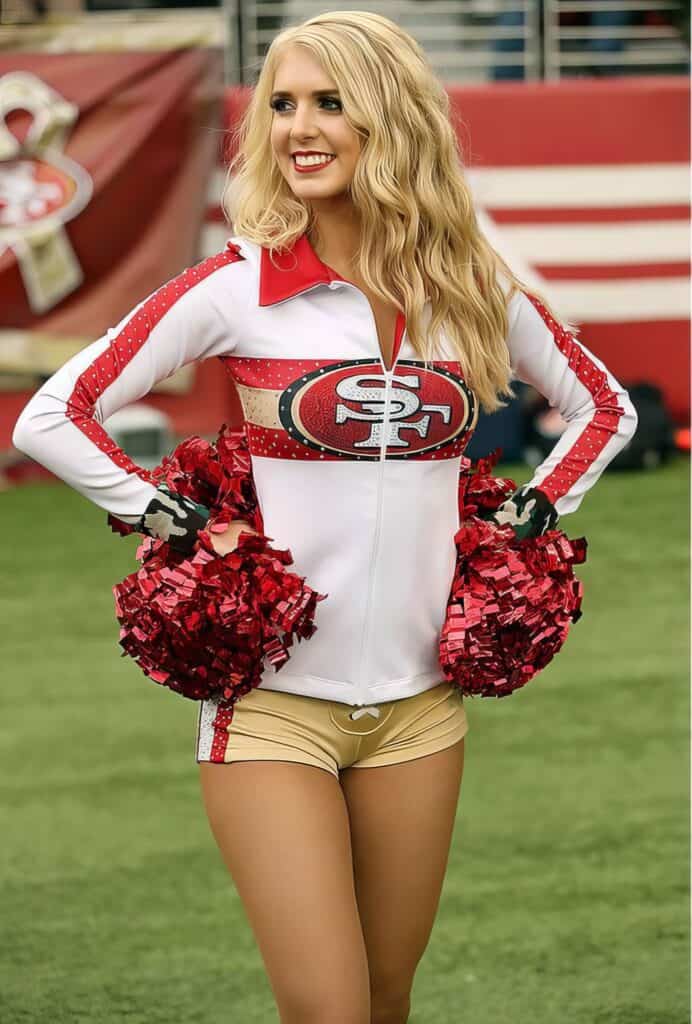 San Francisco 49ers cheerleader in team uniform with pom-poms on football field, promoting sports entertainment and NFL team spirit.