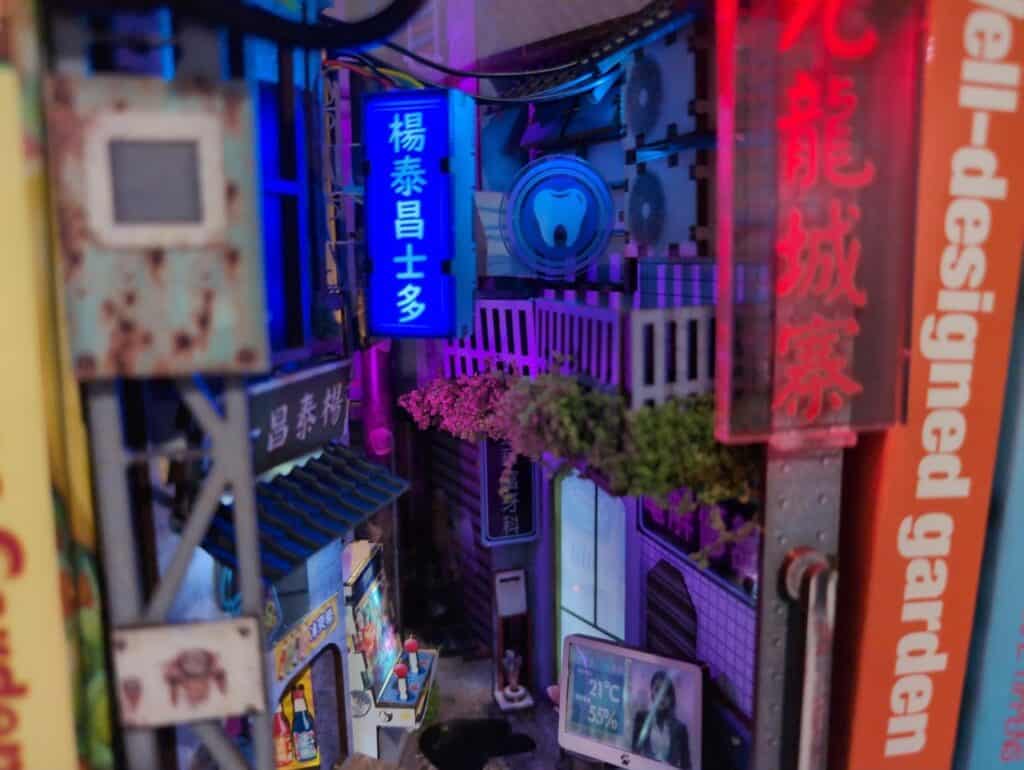 The Perfect Book Nook Gifts for Dads, Husbands & Book-Loving Guys 6 Neon-lit urban street scene with Asian signage and digital displays, vibrant lights and small outdoor elements, reflecting modern city nightlife and Asian cultural influence.